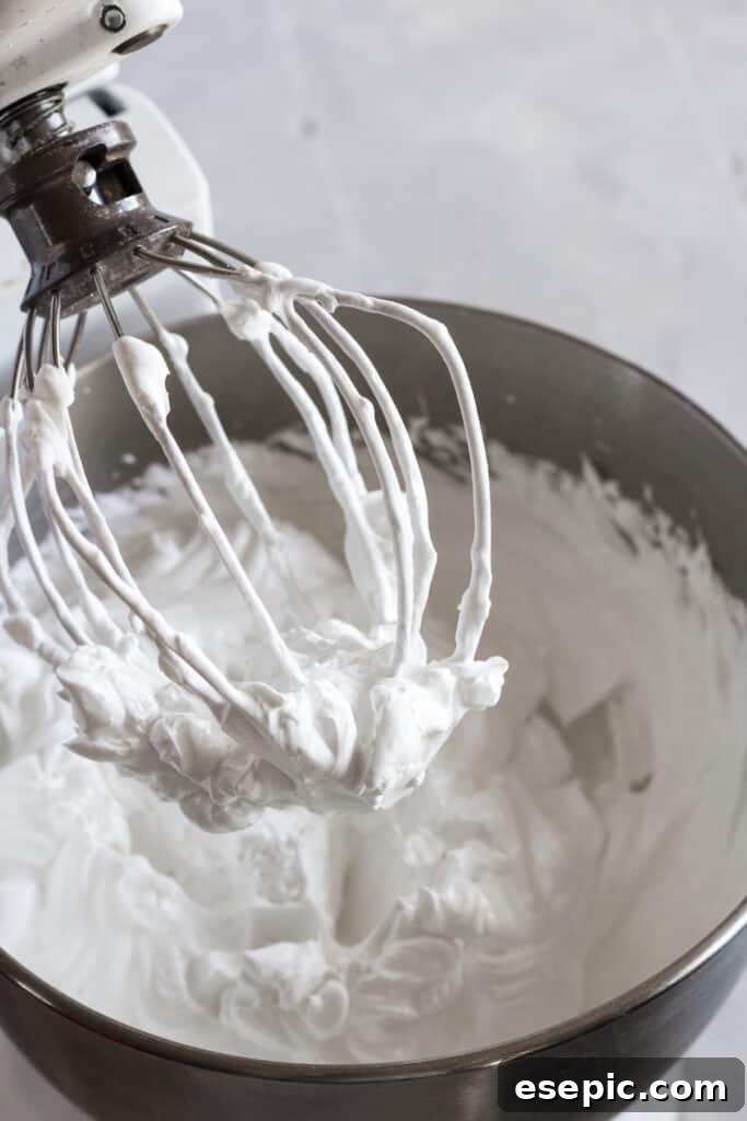 Effortless Strawberry Meringue Nests 7 The whisk attachment of a stand mixer, coated in beautifully whipped, glossy meringue with stiff peaks.
