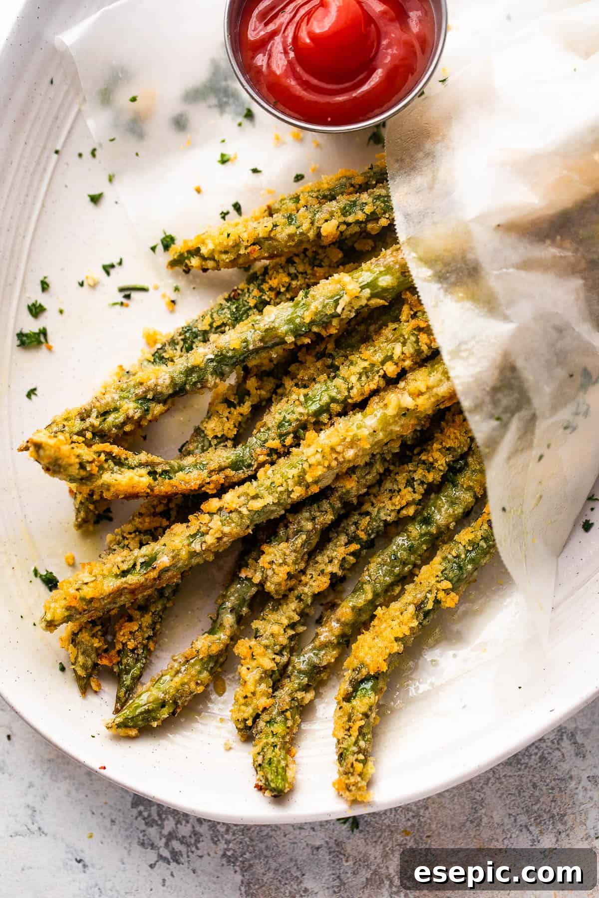Crispy Parmesan Panko Asparagus Sticks 7 overhead shot of baked parmesan panko asparagus fries served with ketchup on the side