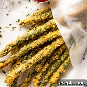overhead shot of baked parmesan panko asparagus fries served with ketchup on the side
