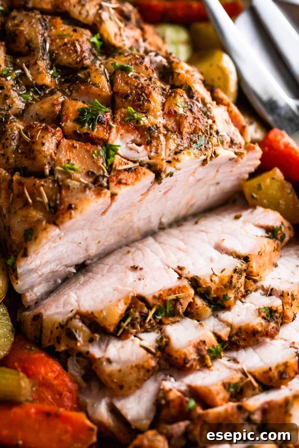 Garlic Herb Pork Loin with Roasted Root Vegetables 7 Close-up shot of baked pork loin roast, expertly sliced and elegantly served with a colorful medley of roasted vegetables.