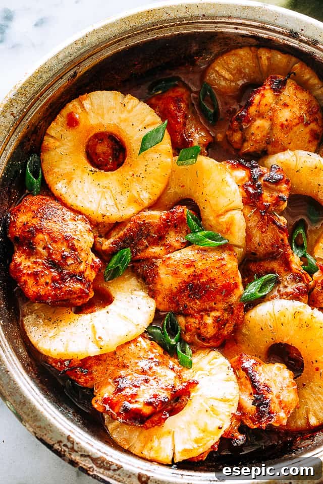 Juicy, tender, and flavorful, these pineapple barbecue chicken thighs are one of my favorite easy weeknight dinner ideas! Done in 20 minutes! A skillet filled with beautifully glazed pineapple barbecue chicken thighs, ready to be served.