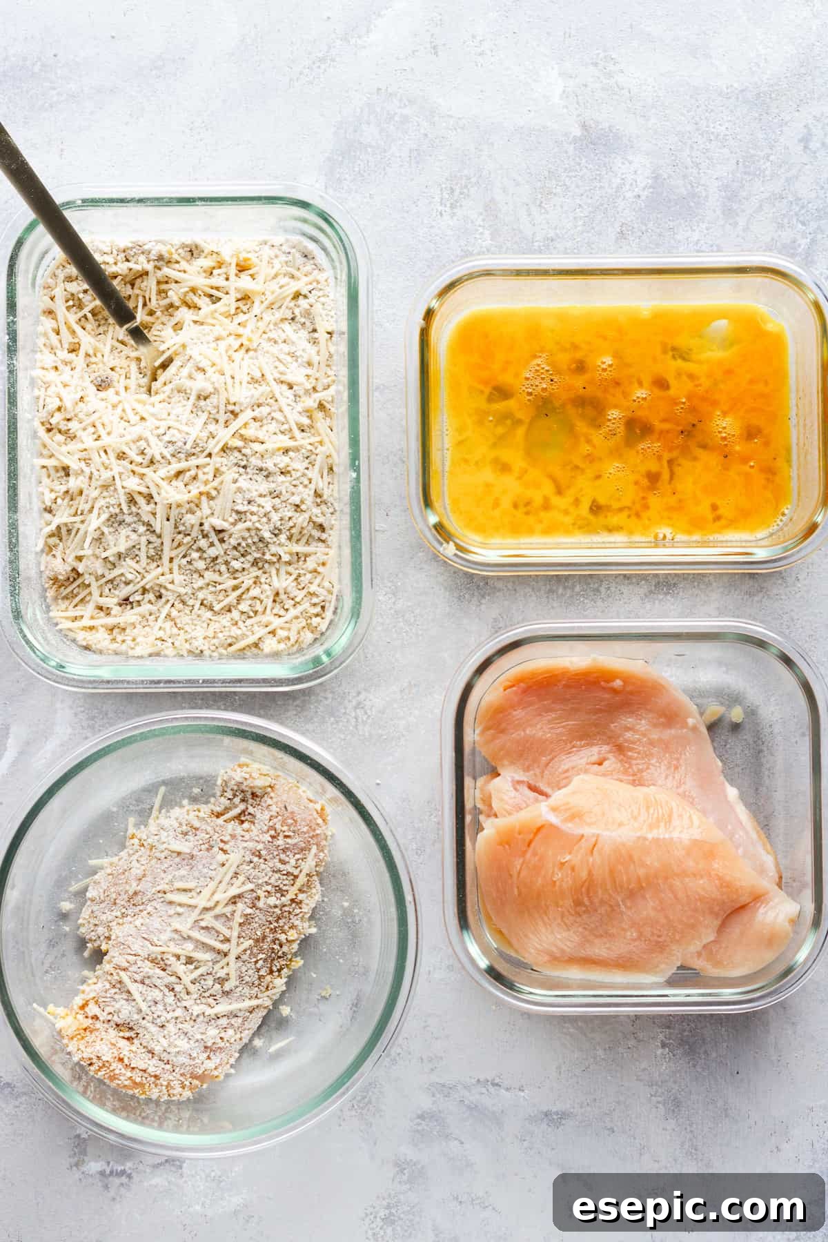 Crispy Air Fryer Chicken Parm 6 A breading assembly line featuring raw chicken breasts, egg wash, dry breading mix, and a fully coated chicken cutlet.