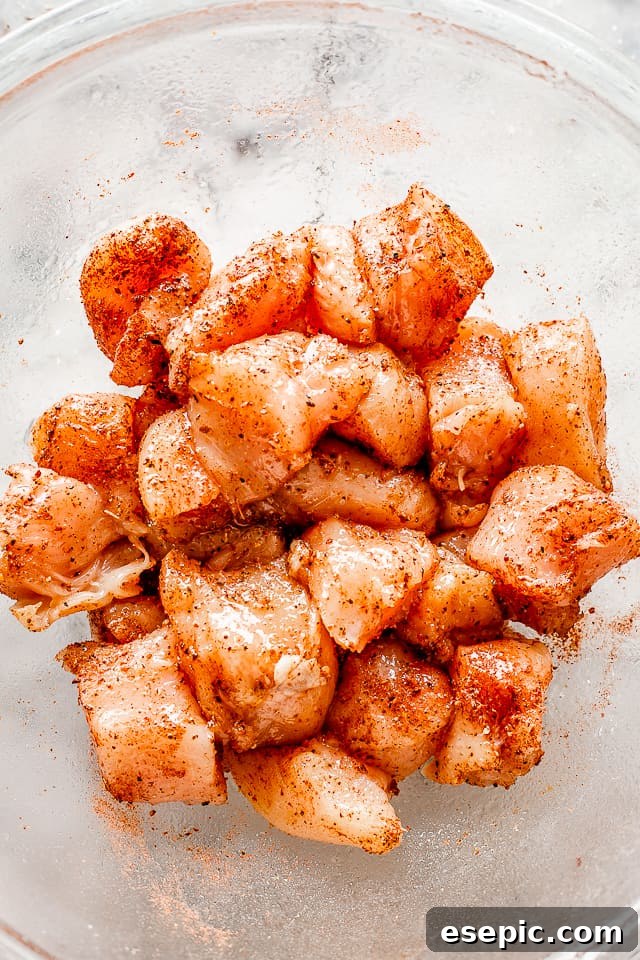 The absolute easiest chicken recipe you will ever see. Taco chicken bites are simple, fun, and full of flavor. Perfect for busy weeknights! Raw cubes of chicken breast seasoned with taco seasoning.