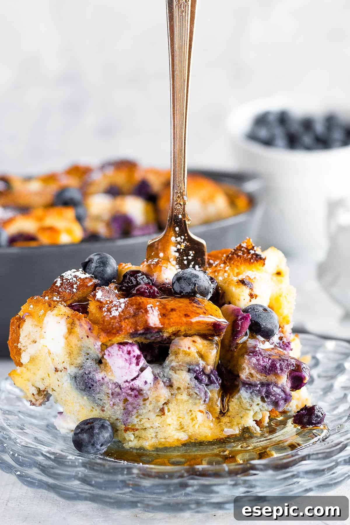 A Piece of Blueberry Casserole with a Fork Sticking Upright Into it