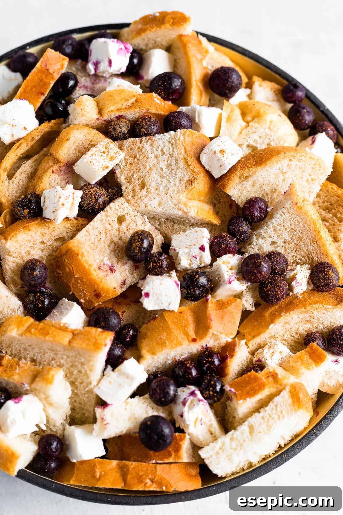 Cubed Sourdough Bread, Blueberries and Cream Cheese Cubes in a Black Bowl