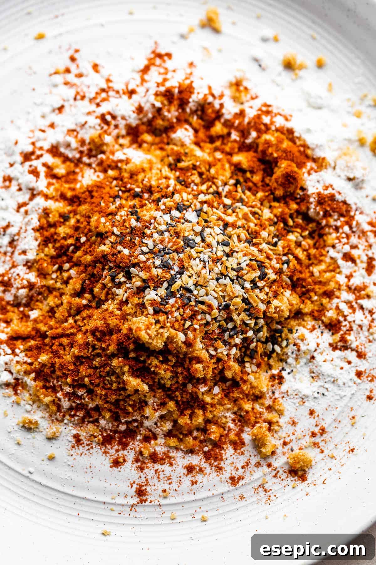 Close-up view of the distinct Everything Bagel seasoning mix, ready to enhance chicken tenders with its unique blend of spices and seeds.