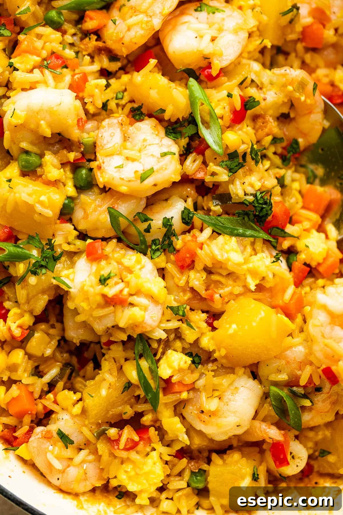 Tropical Pineapple Shrimp Fried Rice 7 Up close photo of Shrimp Fried Rice with pineapple chunks, highlighting individual grains and ingredients.