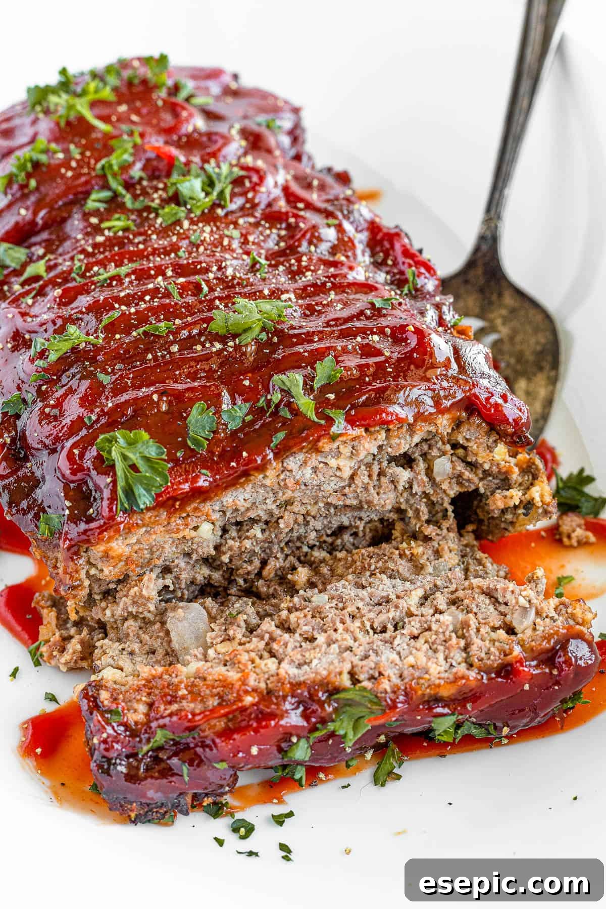 A family-friendly classic, this easy meatloaf recipe gets extra flavor from barbecue sauce, plenty of garlic, and Italian seasoning. A Plate Full of Meatloaf with One Slice Removed