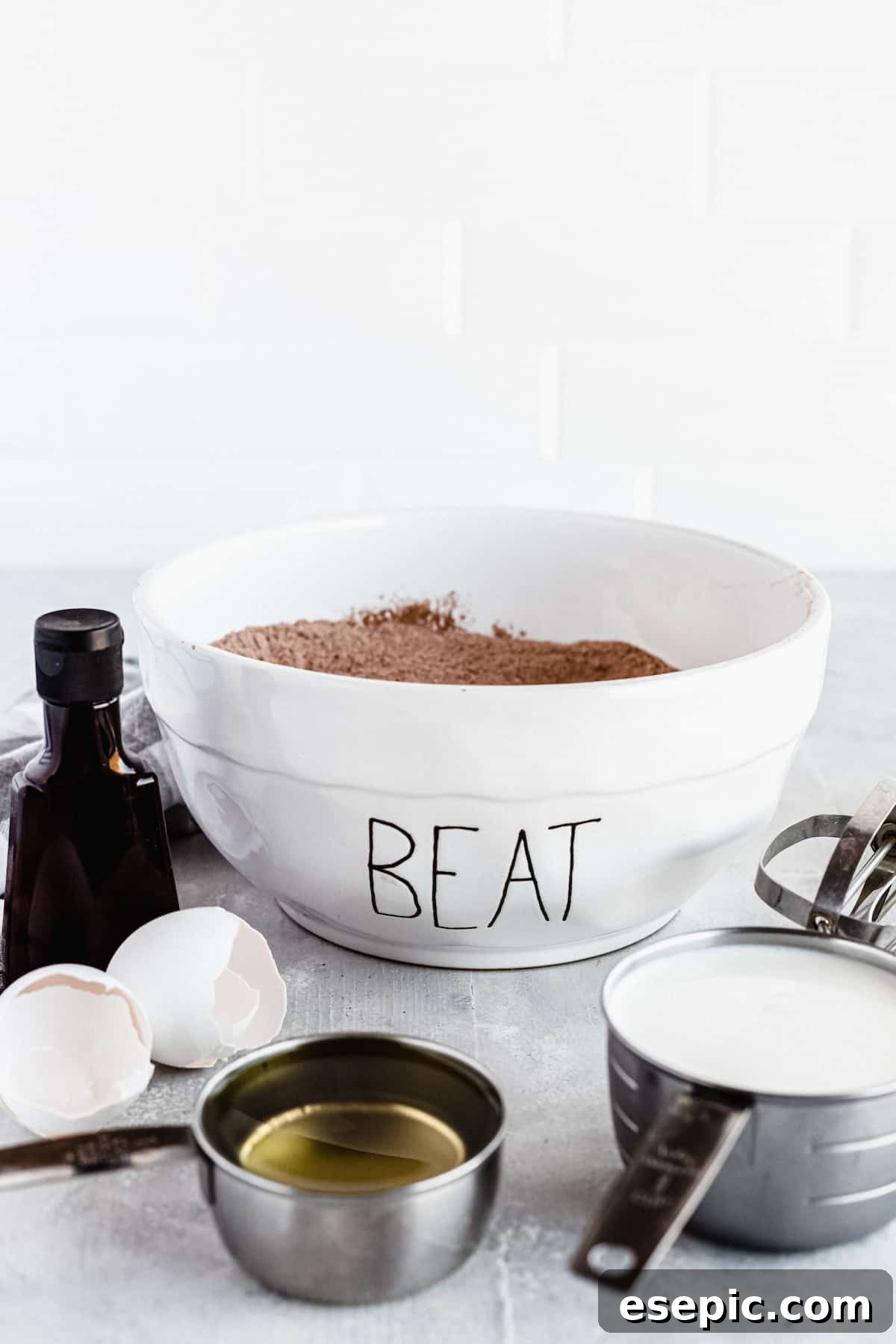 A bowl filled with the dry ingredients for homemade chocolate cake, freshly combined and ready for the wet ingredients.