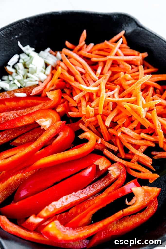 Raw Bell Peppers, Bean Sprouts and Shredded Carrots in a Skillet, ready for stir-frying.
