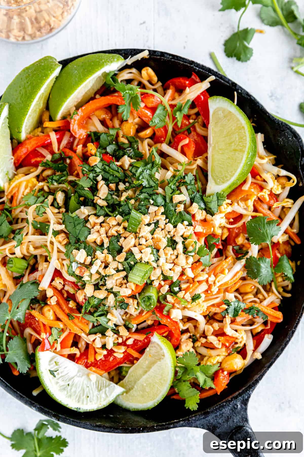 A Plate of Freshly Prepared Pad Thai, adorned with garnishes and a lime wedge.