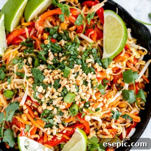 Homemade Pad Thai in a black skillet, perfectly garnished.