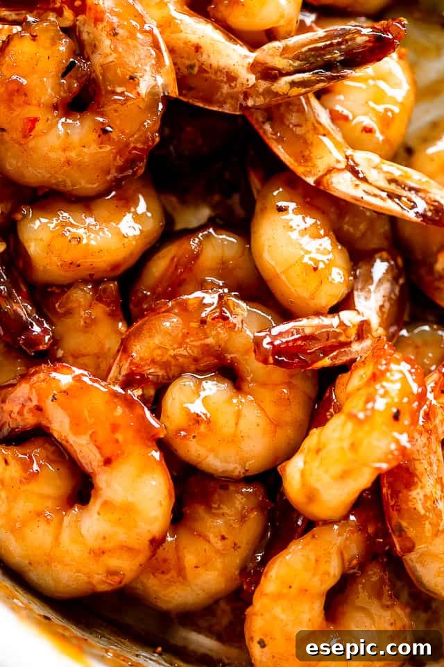 Honey Garlic Shrimp: A quick, easy, and incredibly flavorful shrimp recipe cooked in one skillet with just 5 ingredients in 20 min! A vibrant platter of cooked honey garlic shrimp garnished with fresh parsley and a lemon wedge, showcasing its appealing glaze and perfect doneness.