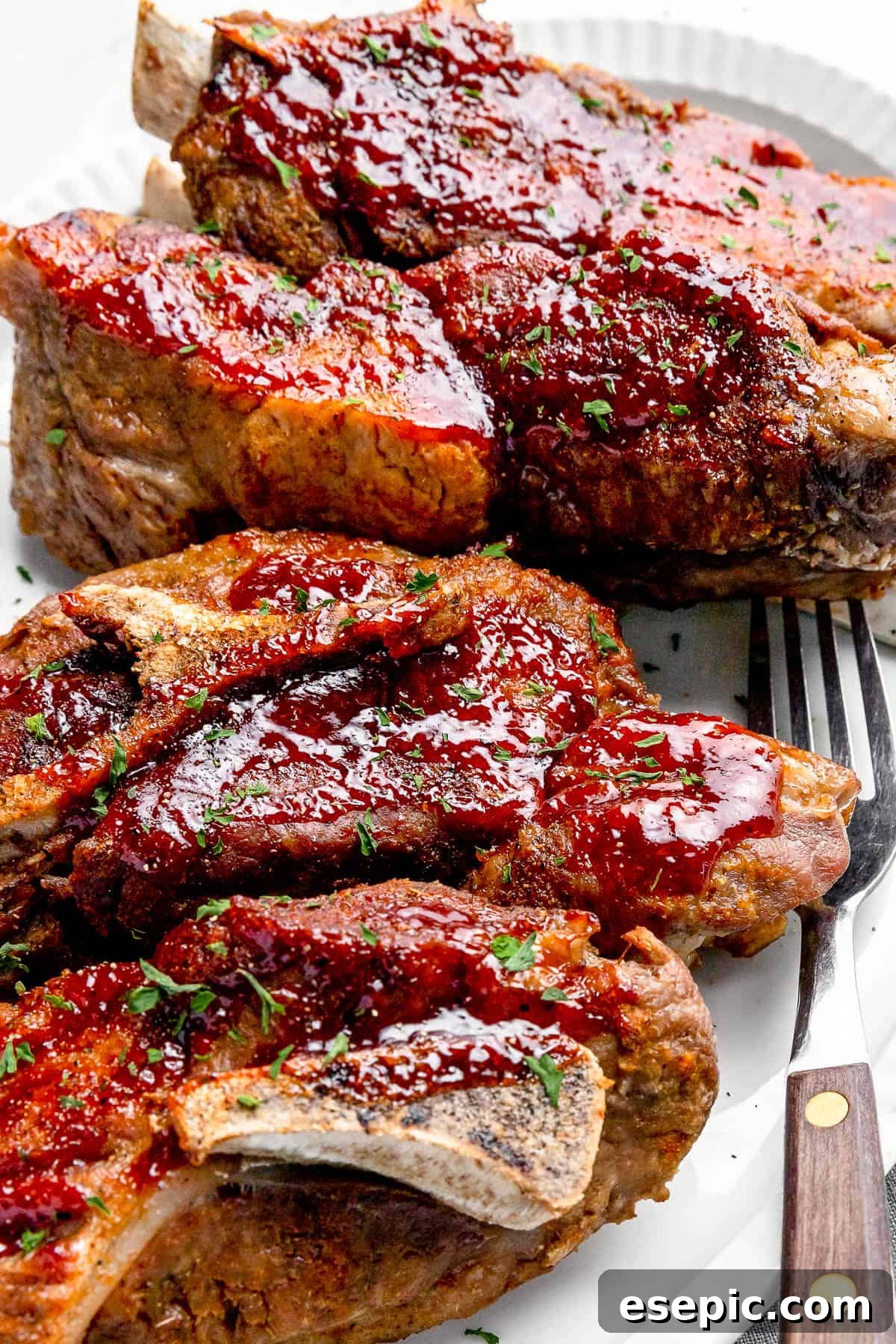 side shot of Instant Pot Ribs on a White Serving Platter with a Small Salad in the Background