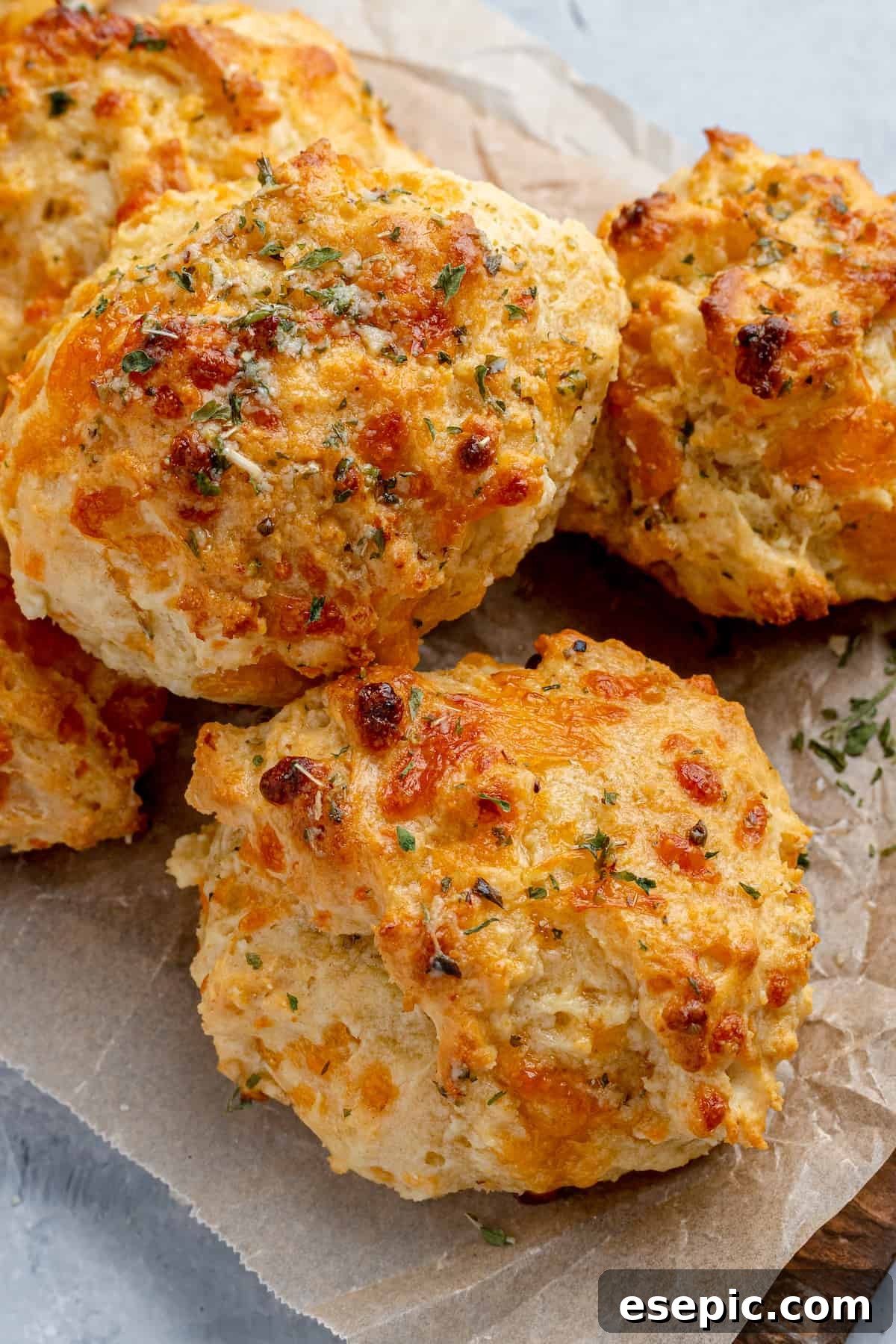A freshly baked Air Fryer Red Lobster Biscuit, golden brown with melted cheddar cheese, on a cooling rack.