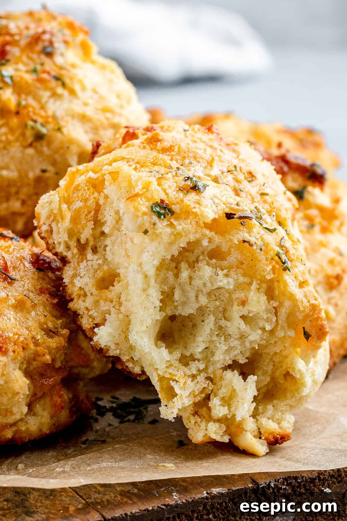 A bite-taken Air Fryer Red Lobster Biscuit showcasing its fluffy, cheesy interior, ready to be enjoyed.