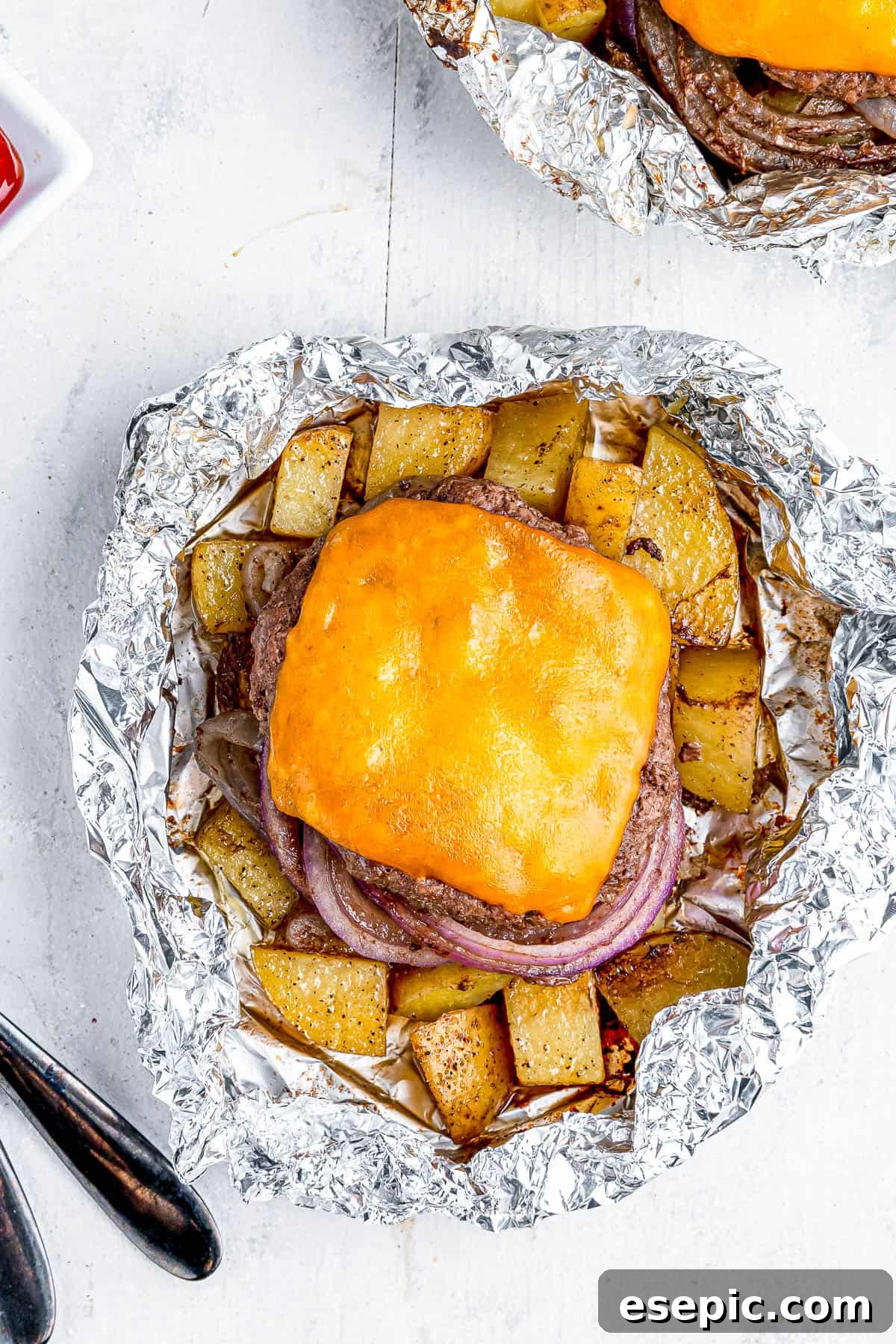 Cheeseburger Foil Dinner with Roasted Vegetables 7 Two cheeseburgers in foil with potatoes