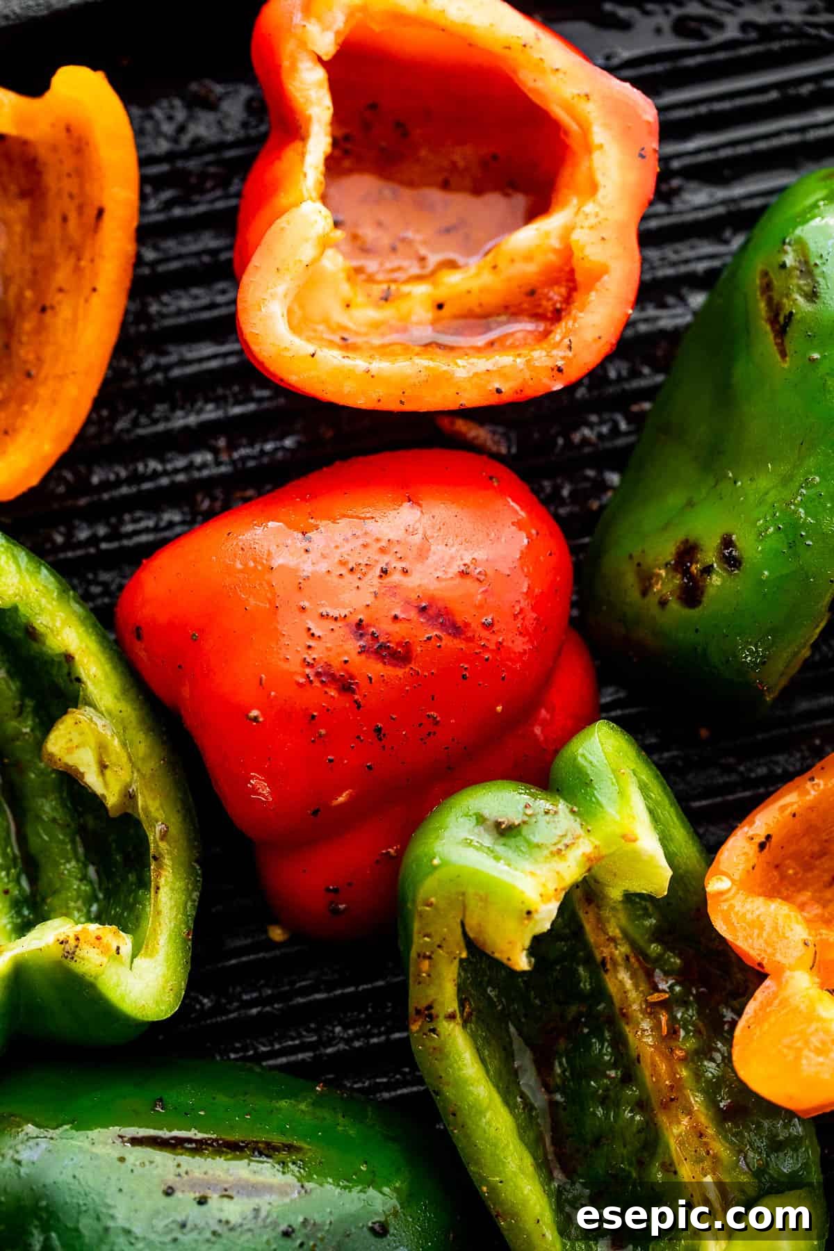 Easy grilled chicken fajitas featuring juicy chicken, onions, and peppers, served in warm tortillas with your favorite toppings. grilling bell peppers on a grill pan