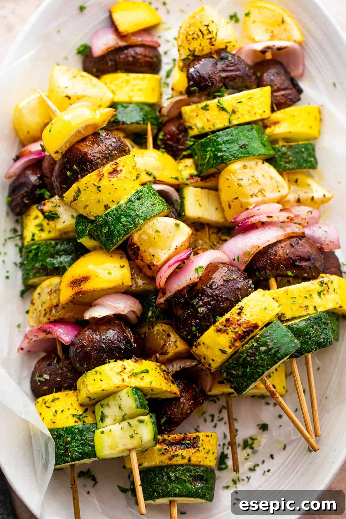 Vibrantly plated grilled summer squash kebabs, garnished with fresh herbs.