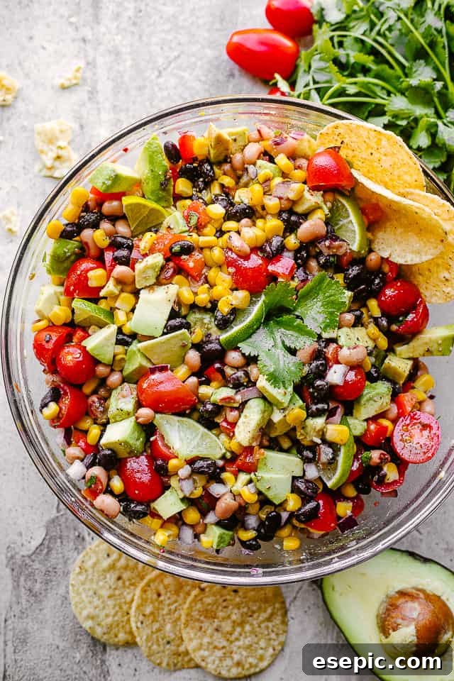 A large glass bowl filled with freshly made Cowboy Caviar, showing the vibrant mix of ingredients, ready to be served.