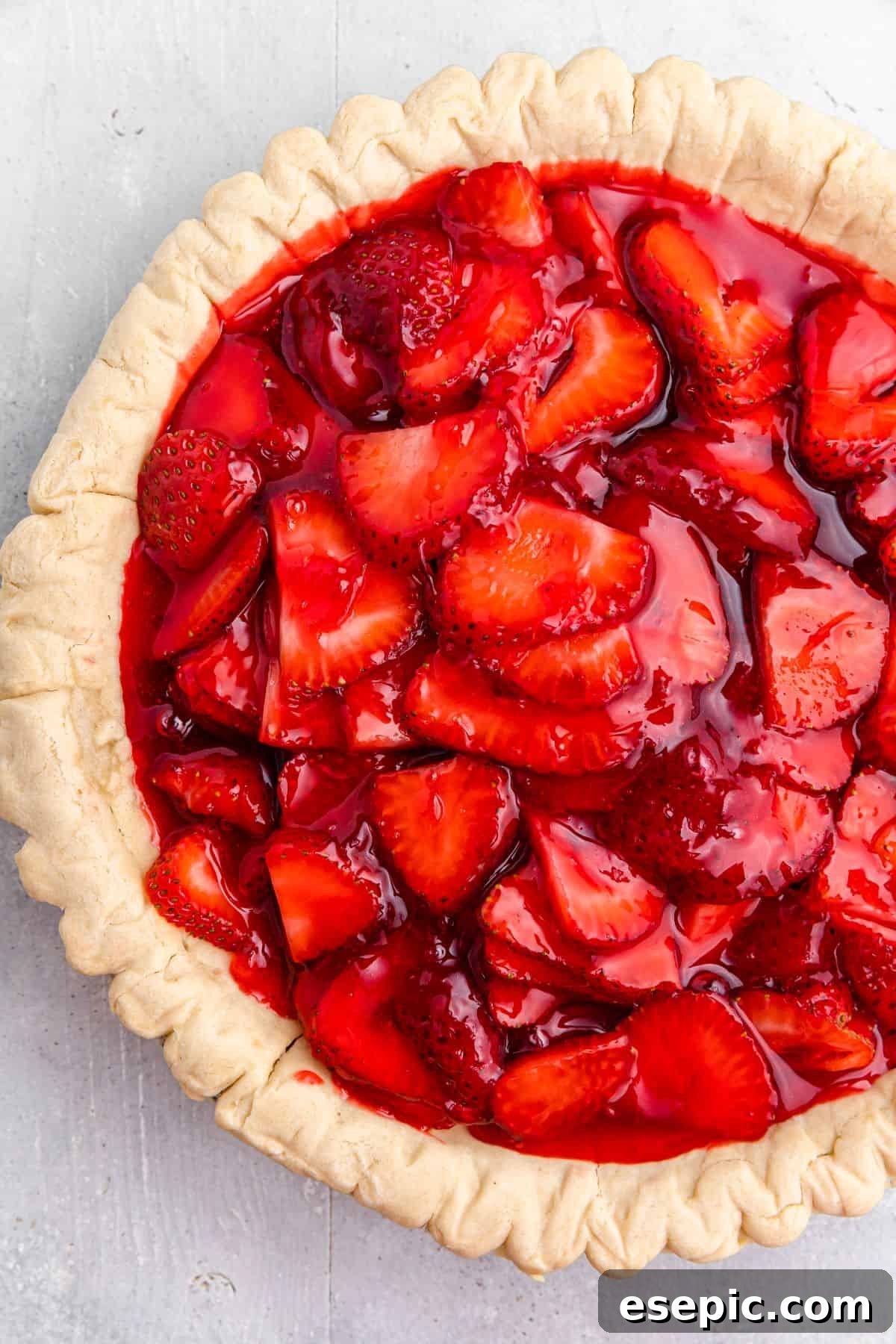 A par-baked pie shell filled with sliced strawberries and strawberry jello filling.