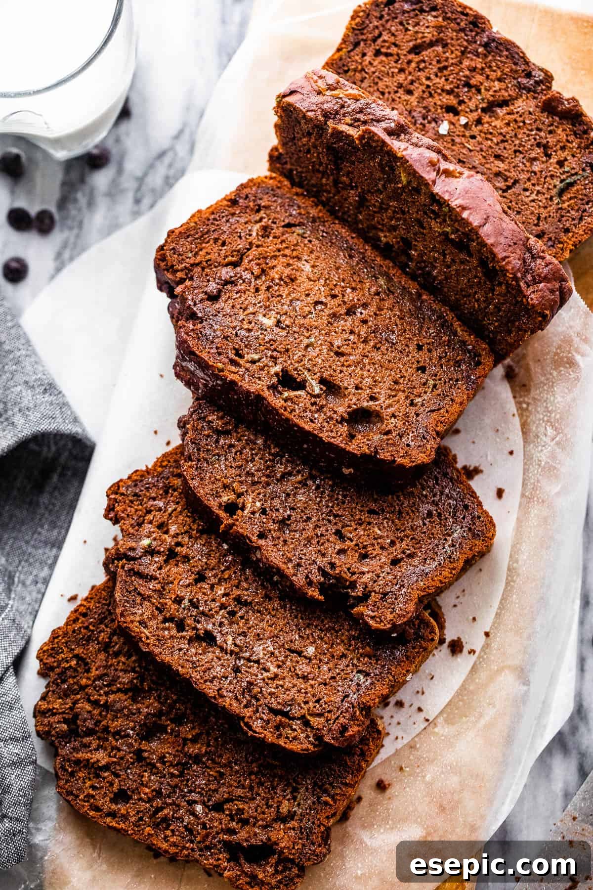 Overhead shot of freshly sliced chocolate zucchini bread, revealing its moist, fudgy texture and bits of zucchini.