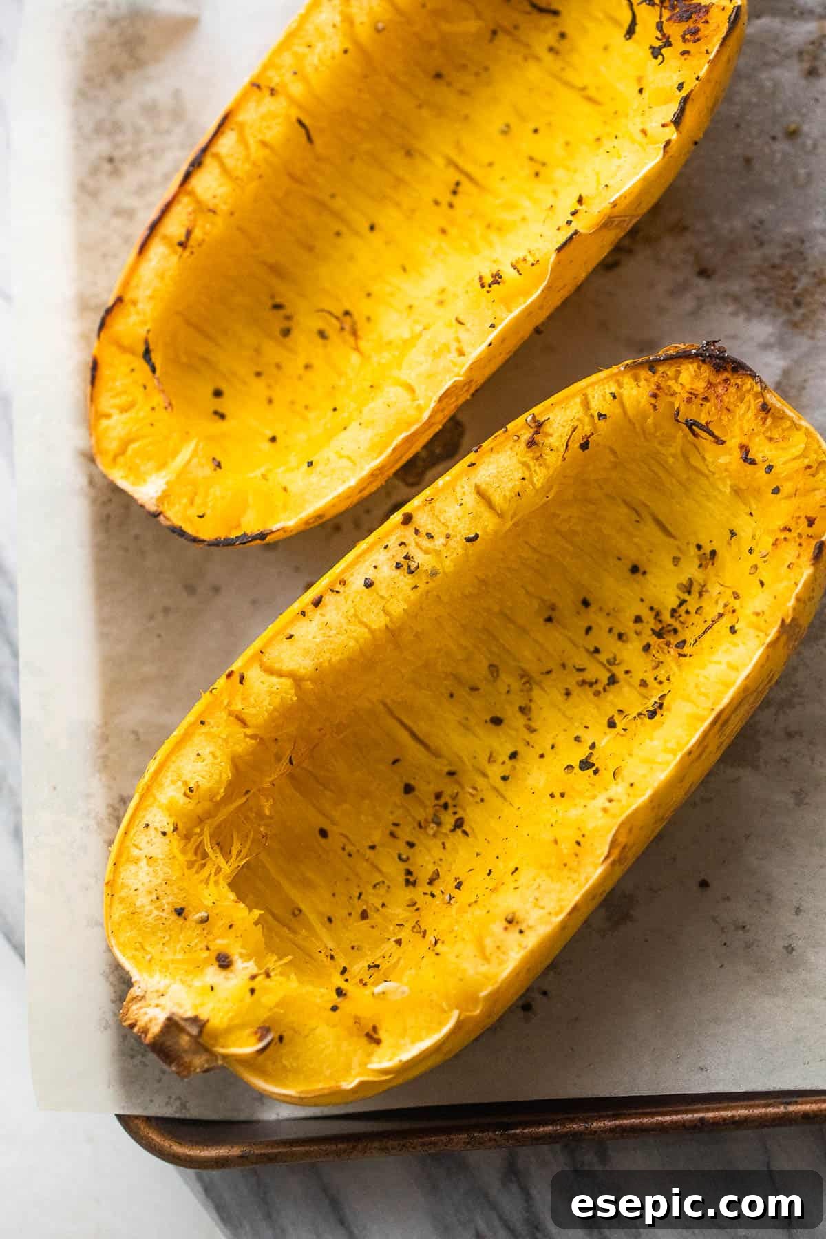 Halved spaghetti squash ready for roasting, showing its unique inner texture