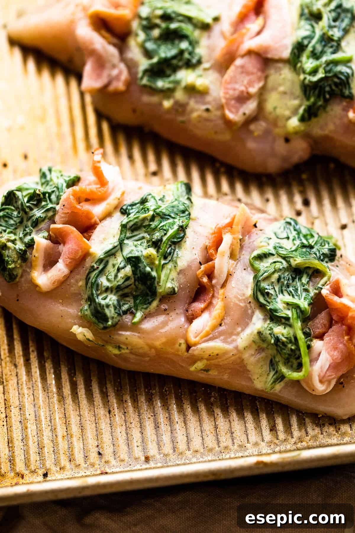 Creamy Spinach Bacon Stuffed Chicken 5 Raw chicken breasts cut hasselback style and generously stuffed with creamed spinach and bacon.