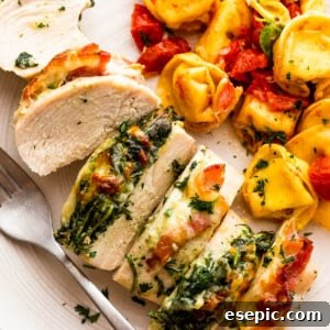cut up stuffed chicken breast served alongside tortellini pasta