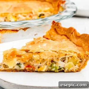 Golden Crust Chicken Delight 8 A baked chicken pot pie, sliced and served, showcasing its comforting appeal.