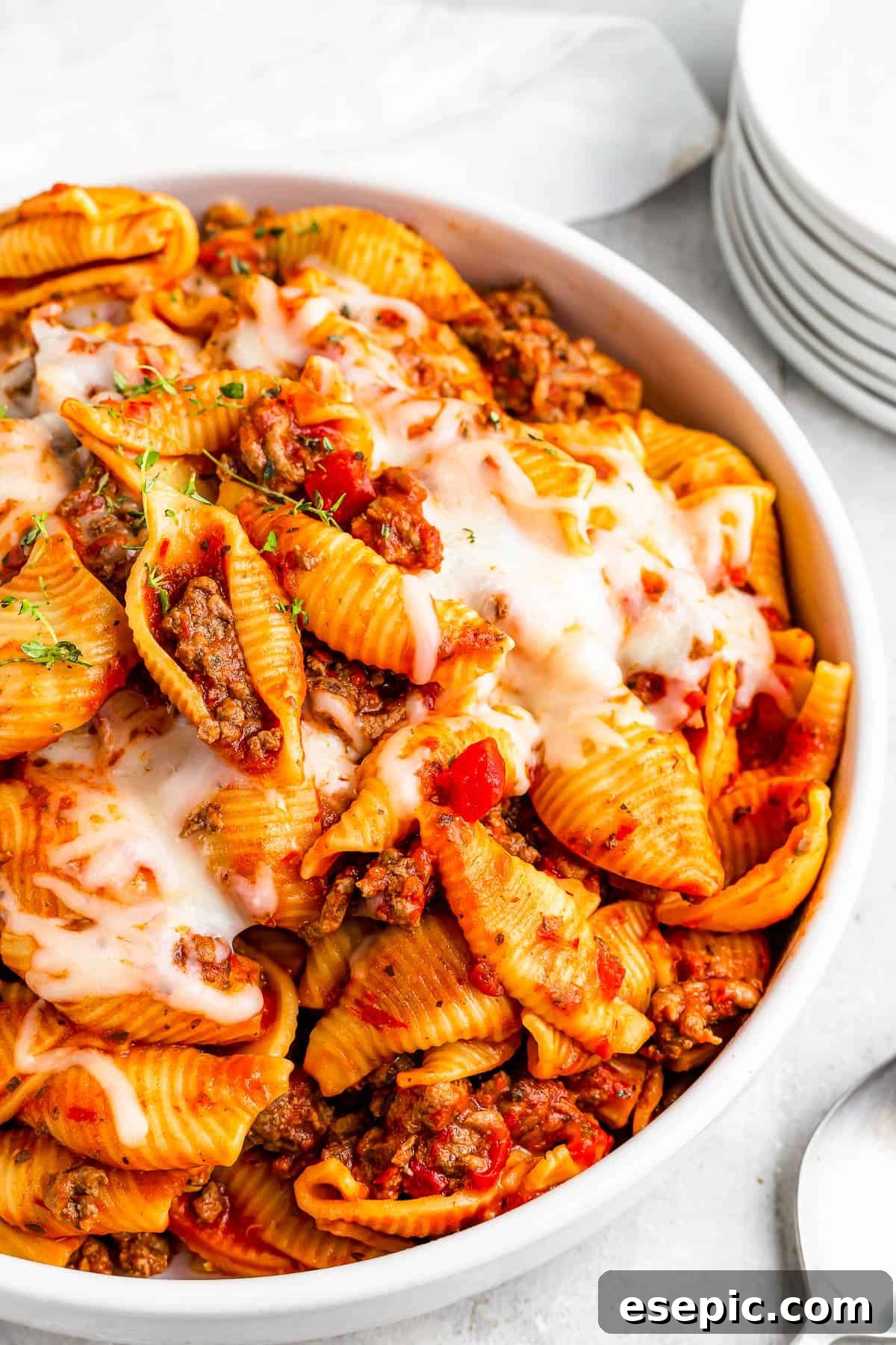 Instant Pot Hearty Beef and Shells 6 a serving of Instant Pot pasta shells and beef in tomato sauce, topped with melted mozzarella.
