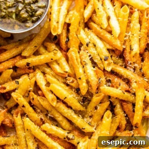 close up of baked pasta chips served with basil pesto