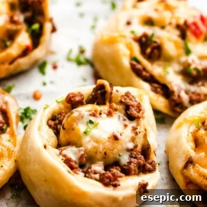 Cooked taco pinwheels on a baking sheet, golden brown and ready to serve.