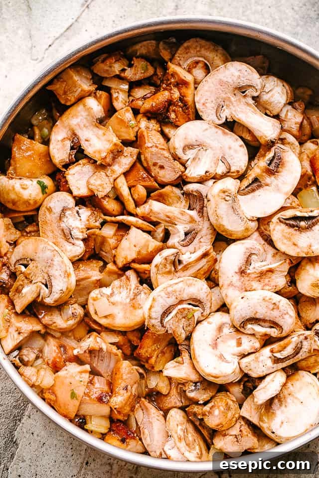Mushrooms sauteing in a pan, turning golden brown and releasing their earthy aroma.