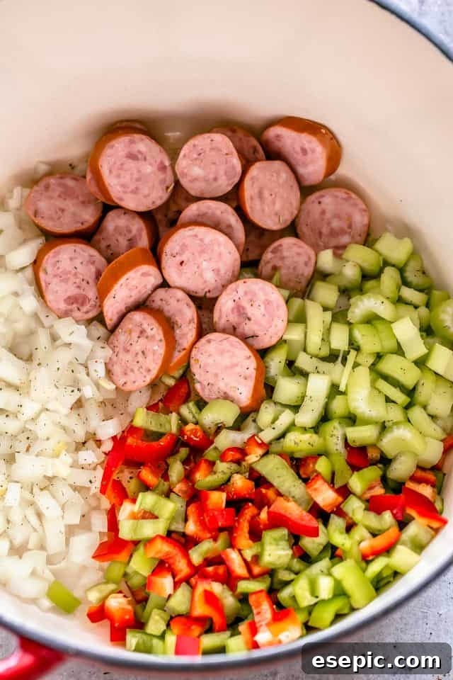 Sausage, celery, onions, and peppers ready to saute in a large pot.