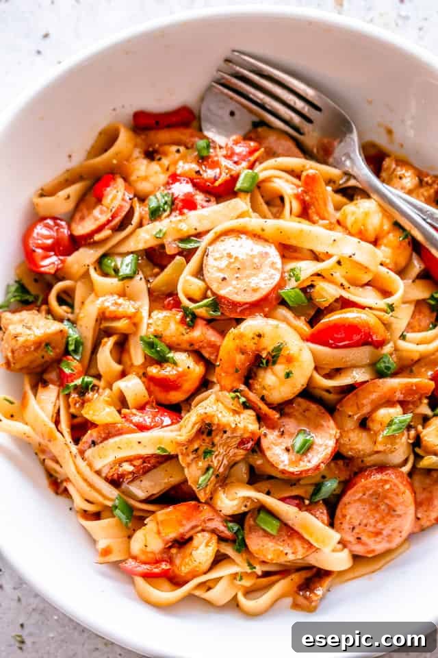 One Pot Jambalaya served in a white dish, garnished with fresh herbs, ready to be eaten.