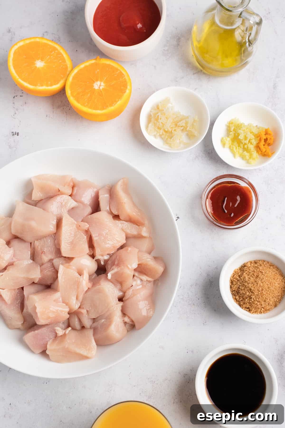 Effortless Instant Pot Orange Chicken 3 Clockwise from top: Tomato paste, oil, grated ginger, minced garlic and orange zest, sriracha sauce, soy sauce, orange juice, chicken