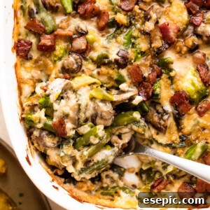 spooning out green bean casserole from a white baking dish.