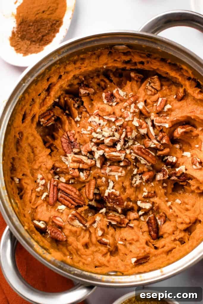 a. pot with mashed sweet potatoes topped with chopped pecans