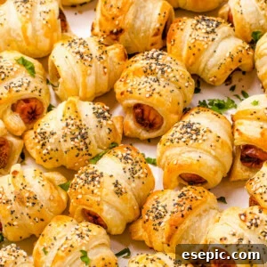 Close up shot of crescent roll hot dogs sprinkled with sesame and poppy seeds.