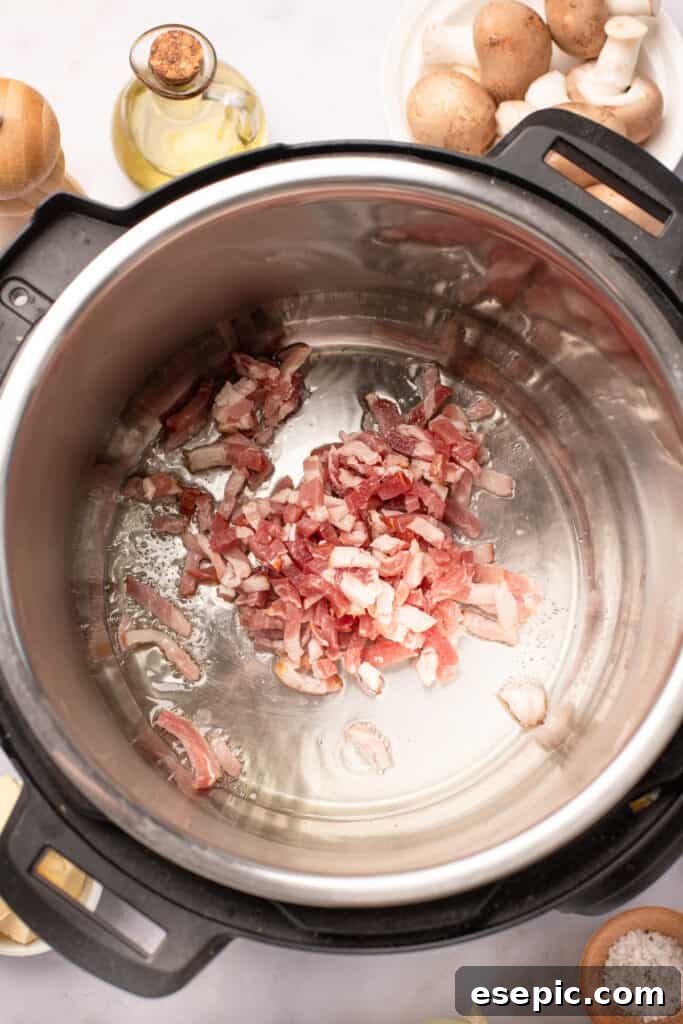 Quick and Classic Instant Pot Coq au Vin 5 Diced bacon frying in an Instant Pot.