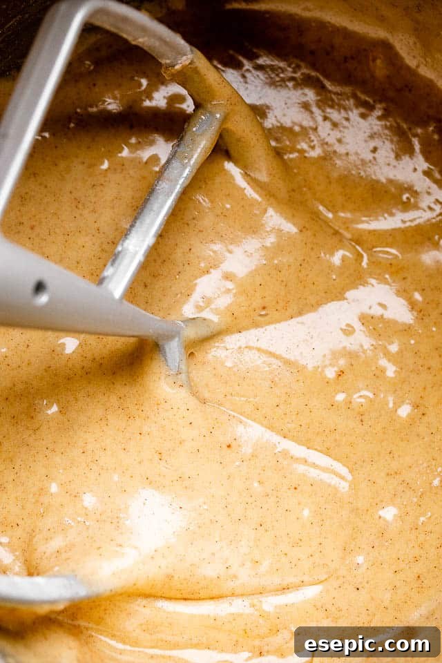 Mixing carrot cake batter in a stand mixer.